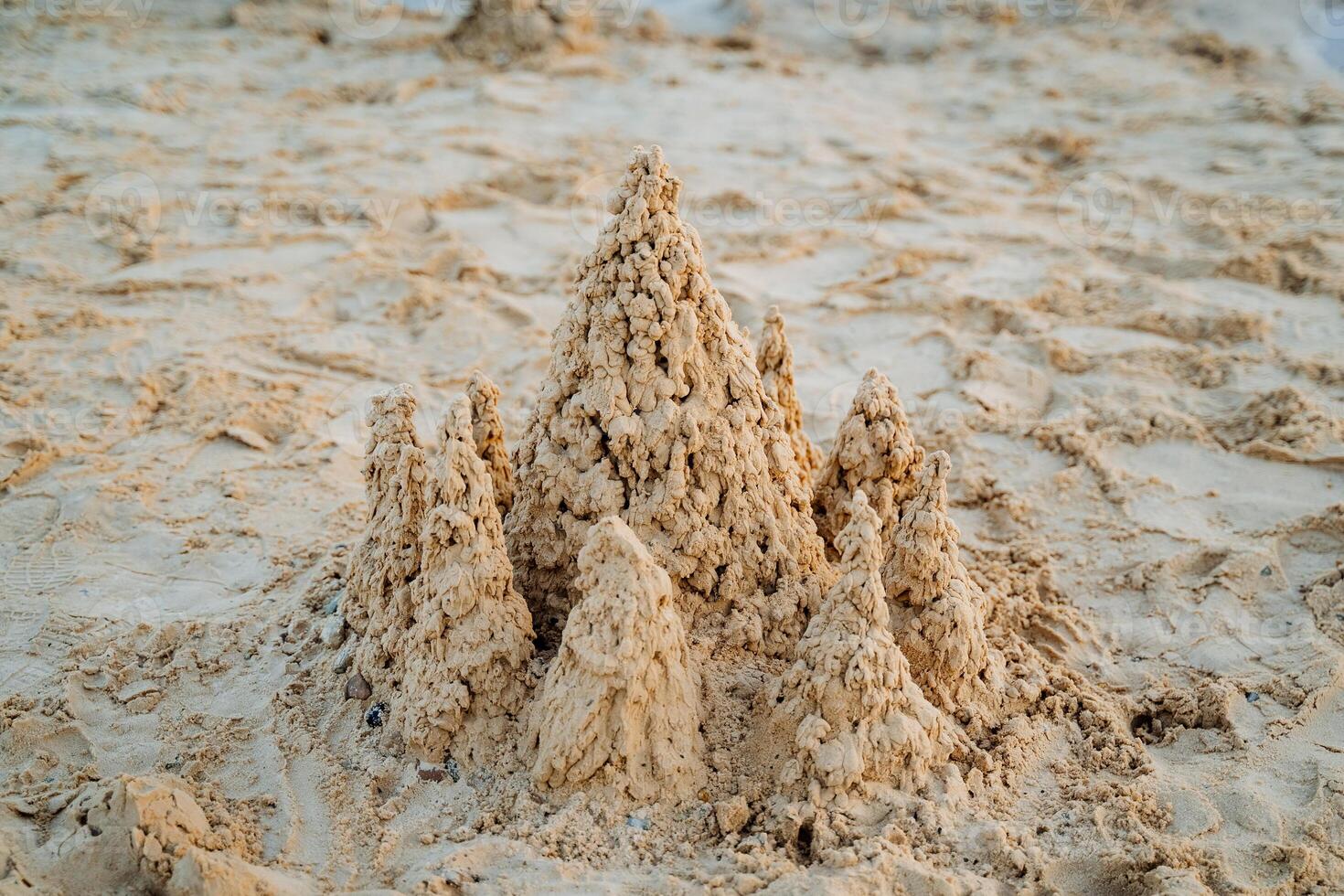 Rest on the sea builds turrets of sand, a sand castle, white fine sand. photo