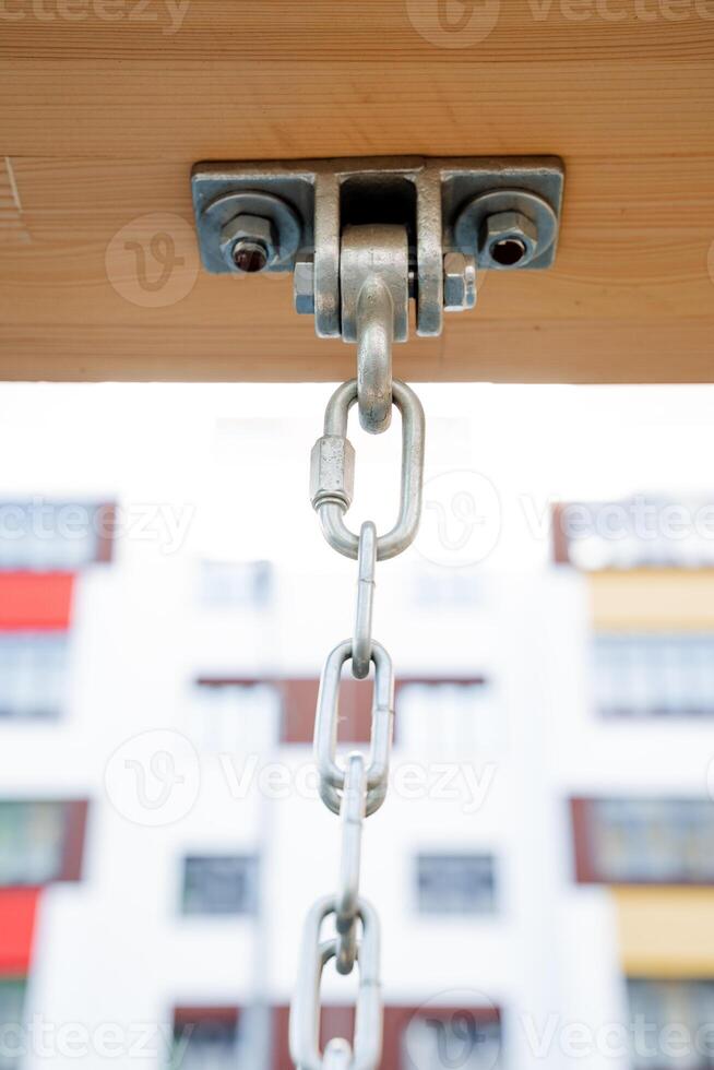 Suspension system for fastening the chain to the log, metal carabiner, building structure, method of hanging loads at height. photo