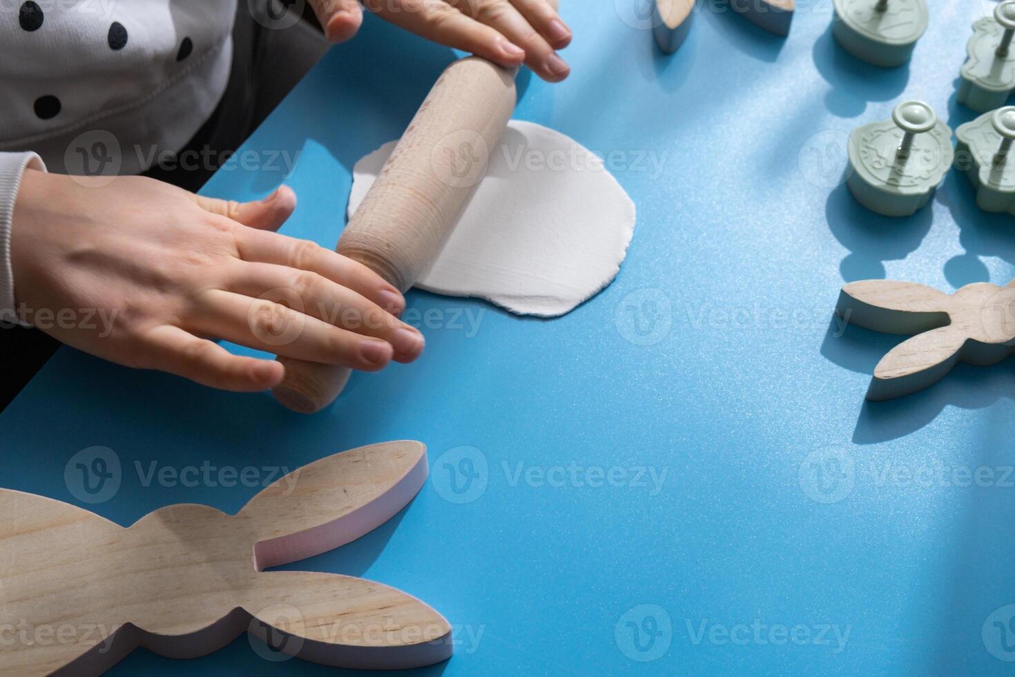 Creator is using white air dry clay for making decor to EASTER holiday. Creating hobby recreation activity that involves fingers. DIY crafting Modern art photo