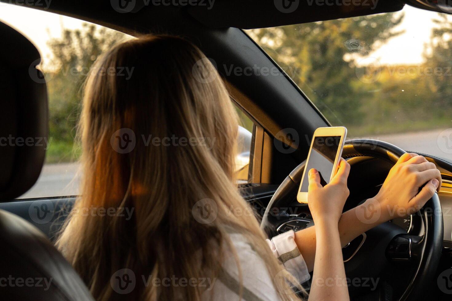 Womandriver using mobile phone paying for parking and navigating in the city while stopped on the side of the road. Self road trip, technology, travel and people concept photo