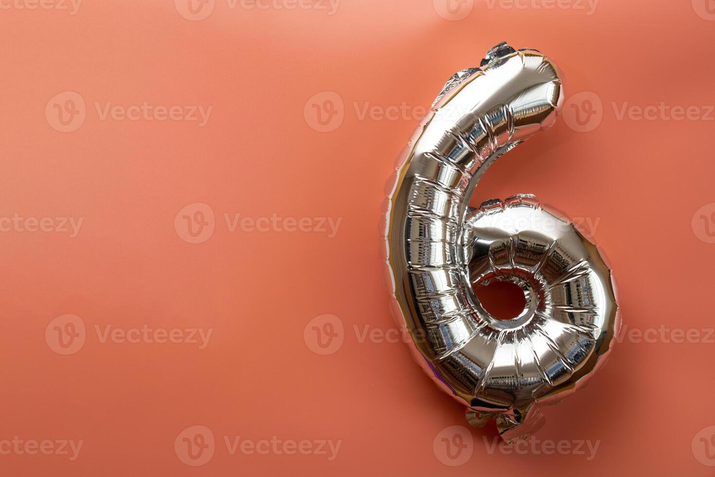 6 six metallic balloon isolated on pink background. Greeting card silver foil balloon number Happy birthday holiday concept. Copy space for text. Celebration party congratulation decoration photo