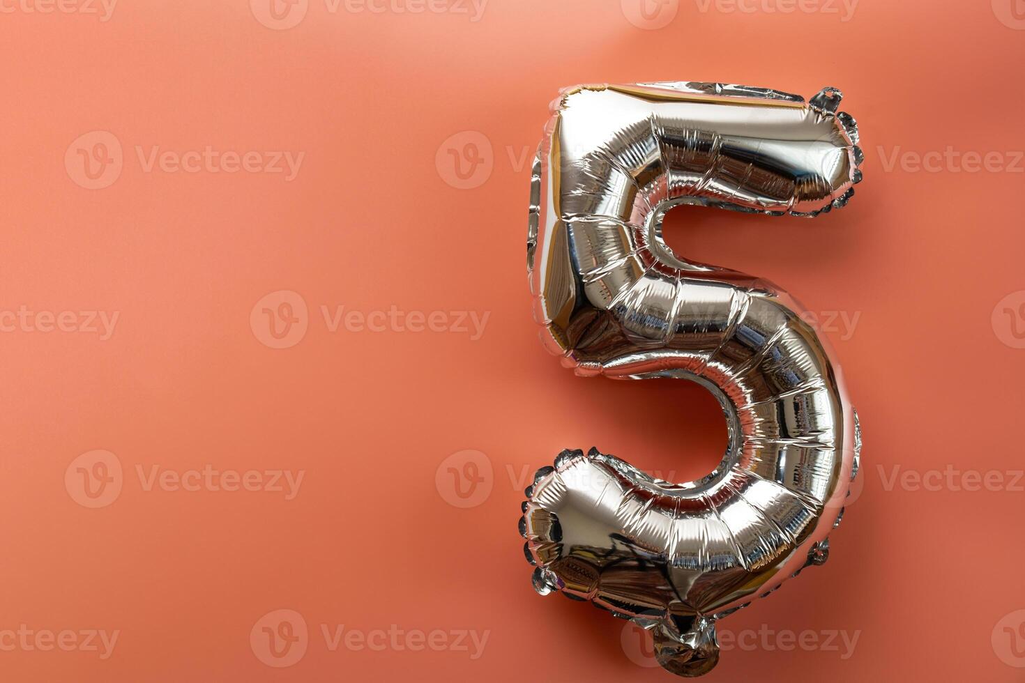 5 five metallic balloon isolated on pink background. Greeting card silver foil balloon number Happy birthday holiday concept. Copy space for text. Celebration party congratulation decoration photo