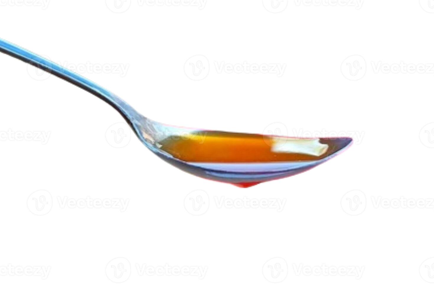 Spoon of honey isolated on white background photo