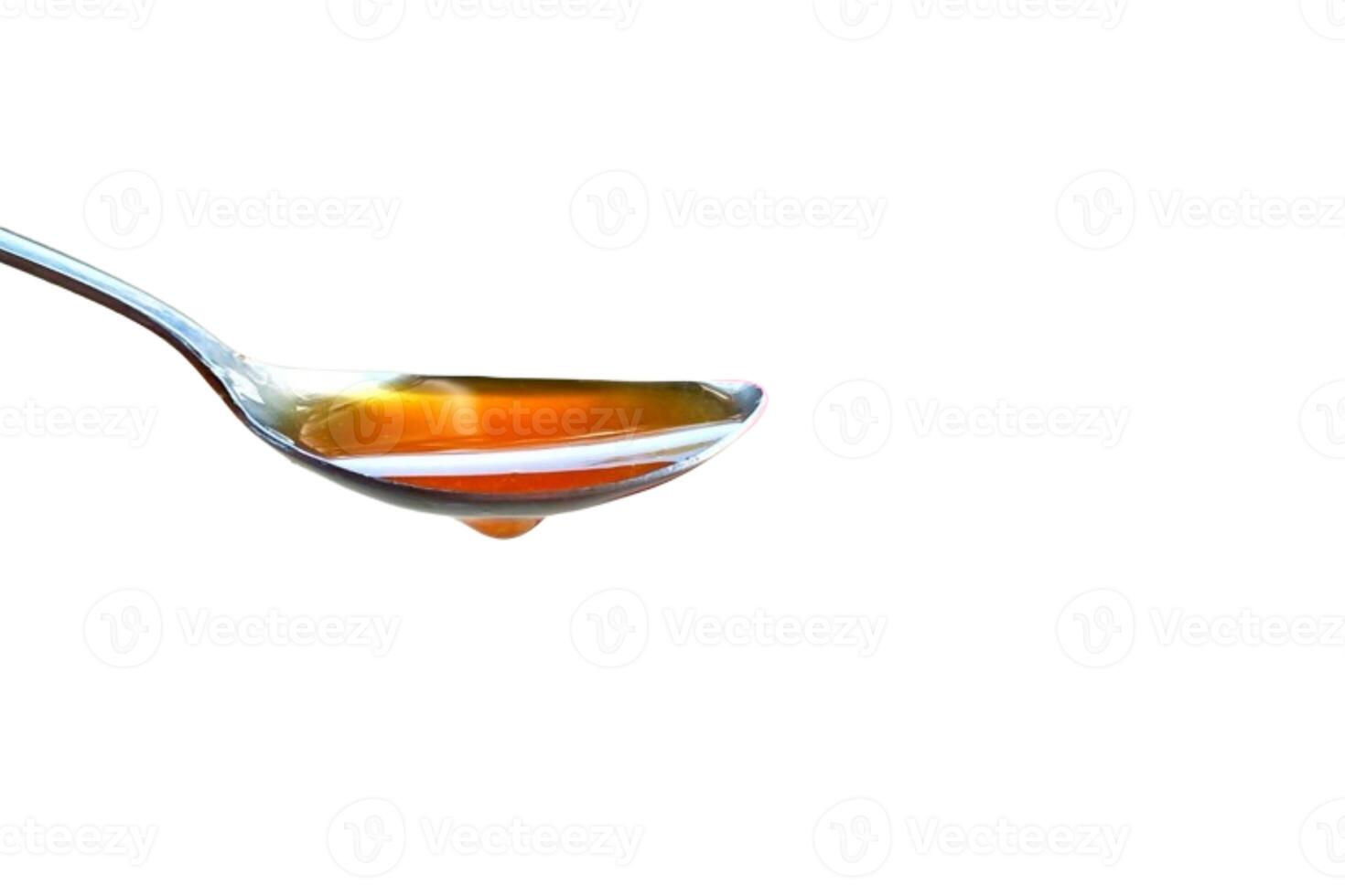 Spoon of honey isolated on white background photo