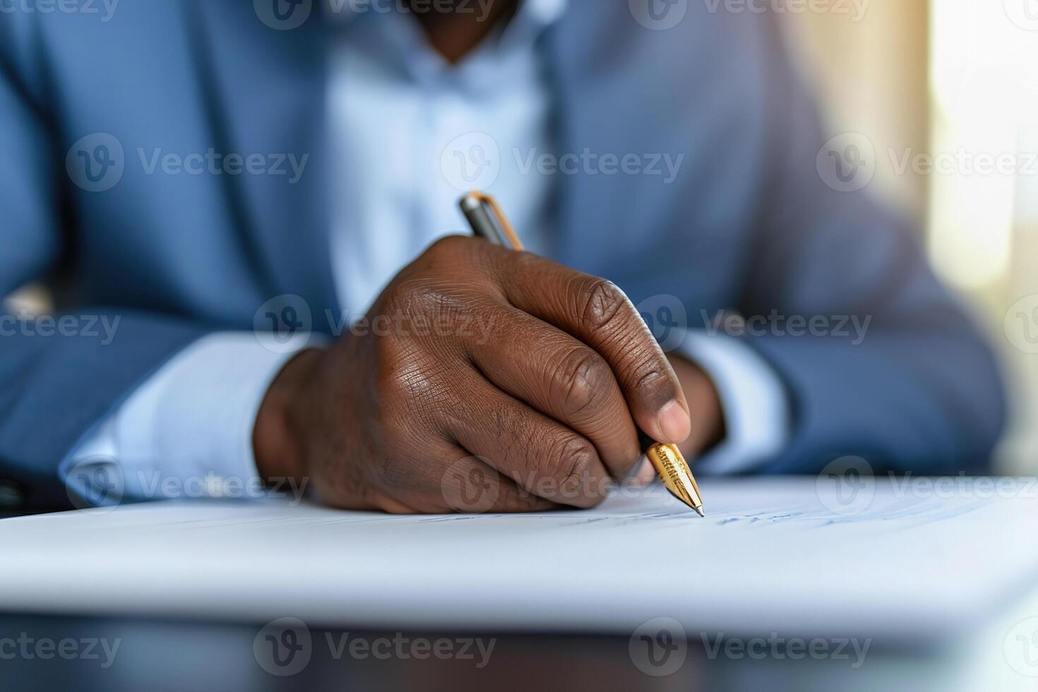 A senior African businessman writing with a pen on a piece of paper. photo