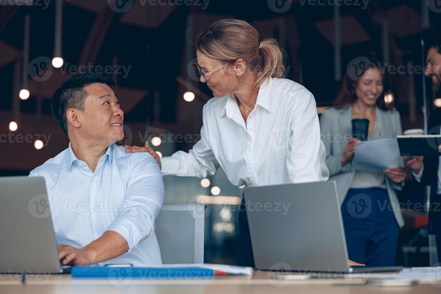 mature female boss discussing online project with employee showing presentation photo
