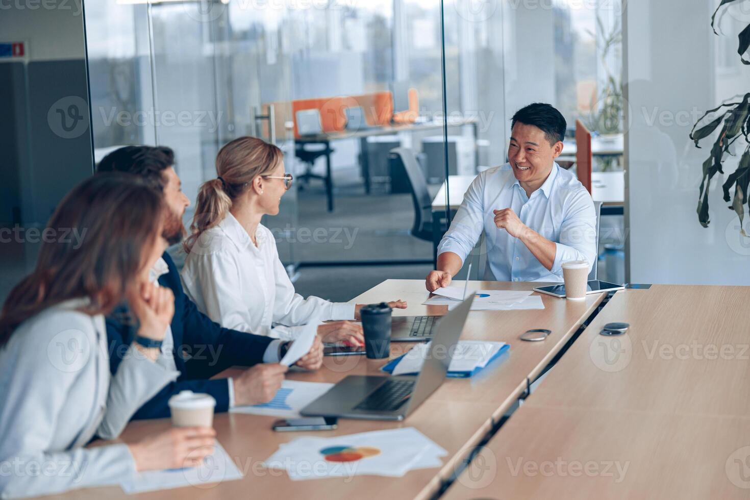 Young and successful team of businessmen working and communicating together in an modern office photo