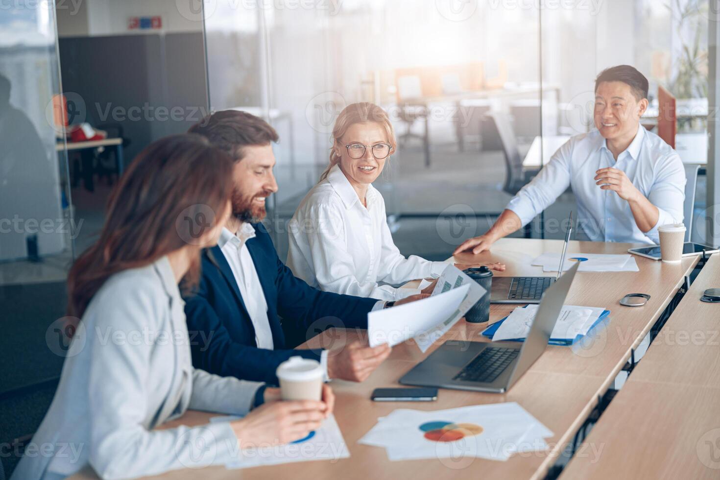 Confident and successful team. Group of modern people are working together in office photo