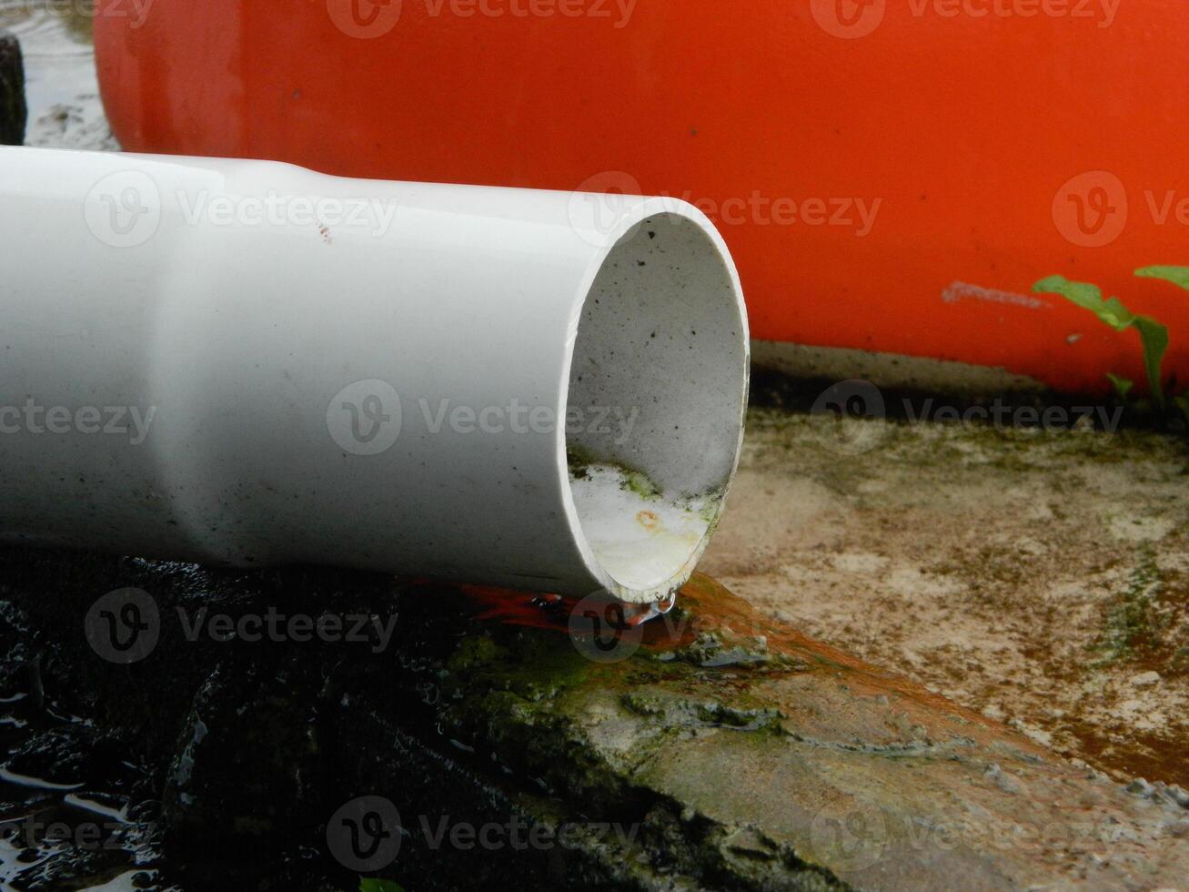 Photo of rainwater from pipes and floors on the top floor of an urban building