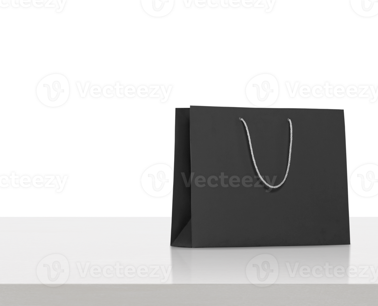black paper bag on white wooden table, transparent background png