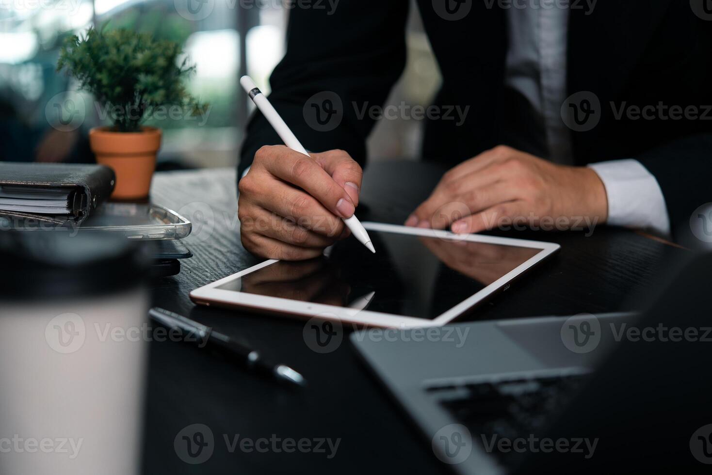 Businessman working hands a digital tablet with a stylus pen signing documents, modern creative work or design planning. photo