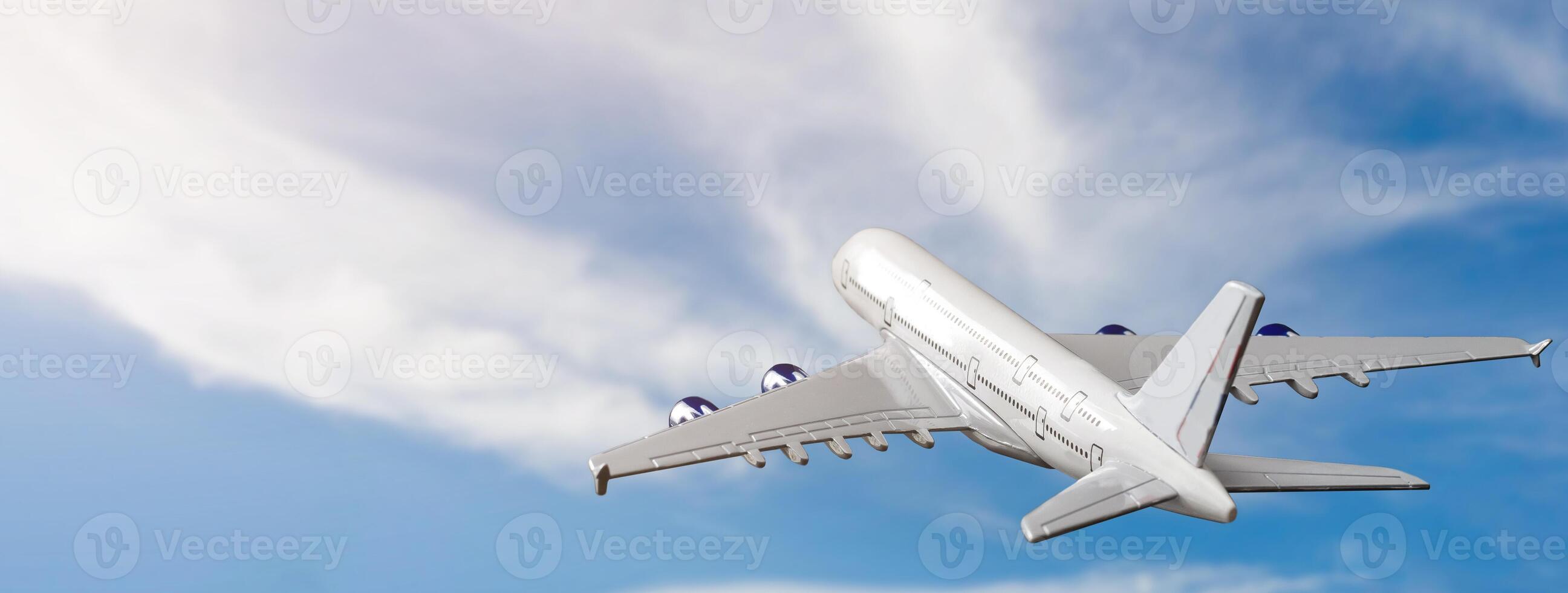 White passenger airplane flying in the sky amazing clouds in the background - Travel by air transport. photo