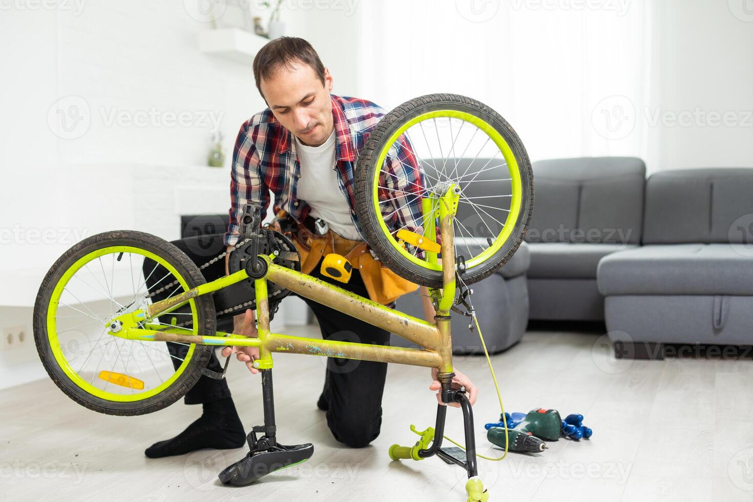 Male worker at the machine tool checks bicycle rim photo