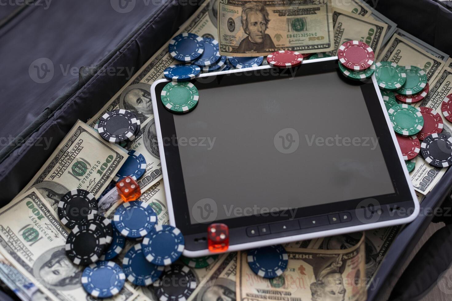 Tablet computer, money and ball for playing basketball on dark background. Concept of sports bet photo