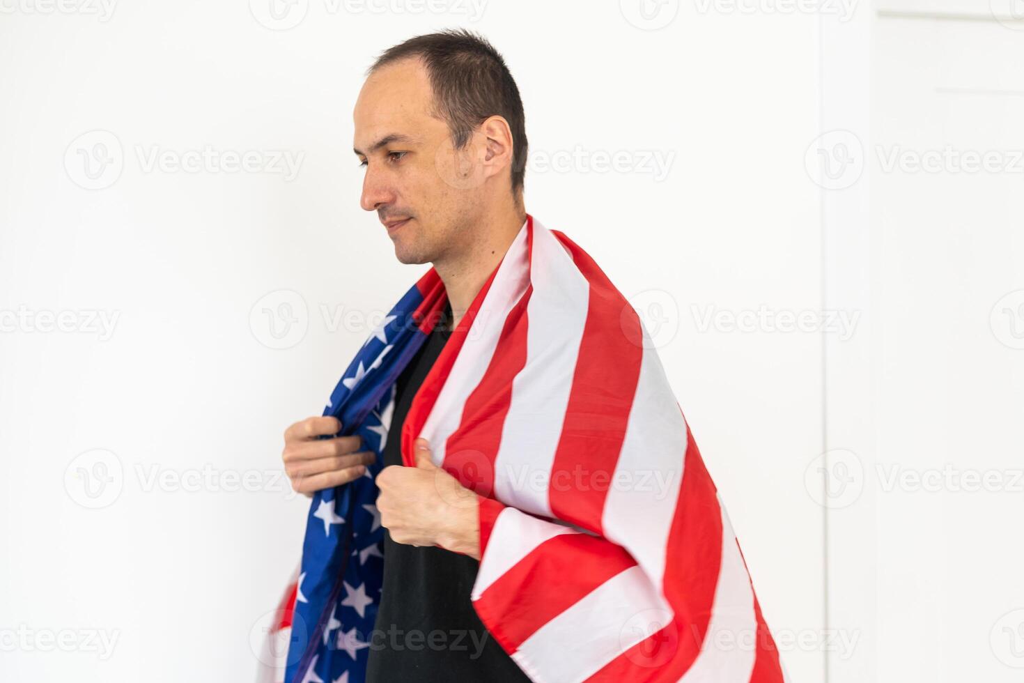 Caucasian businessman holding the flag of America isolated on white background. photo