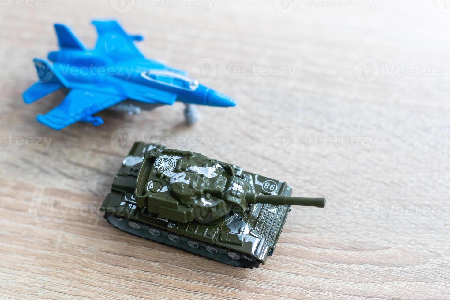 The image shows models of tanks and fighter jets on a white background, close up. photo