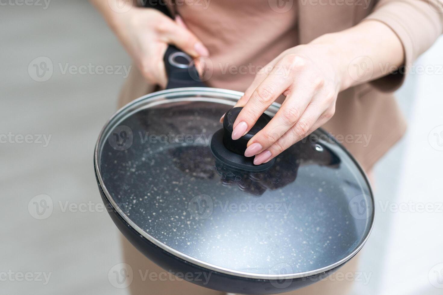 New Frying pan isolated in hand on white background. photo
