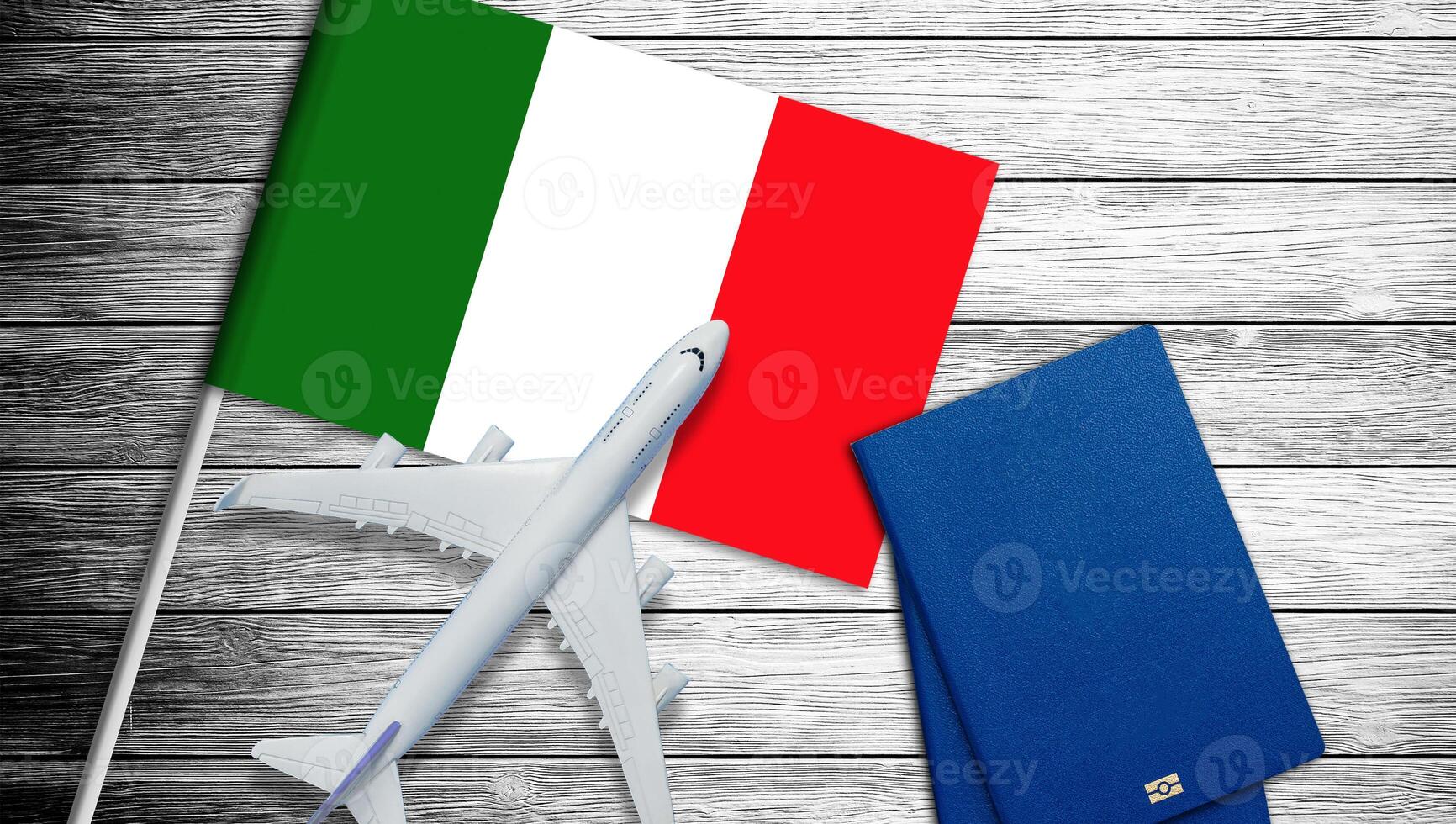 Toy airplane placed on the national flag of Italy. photo