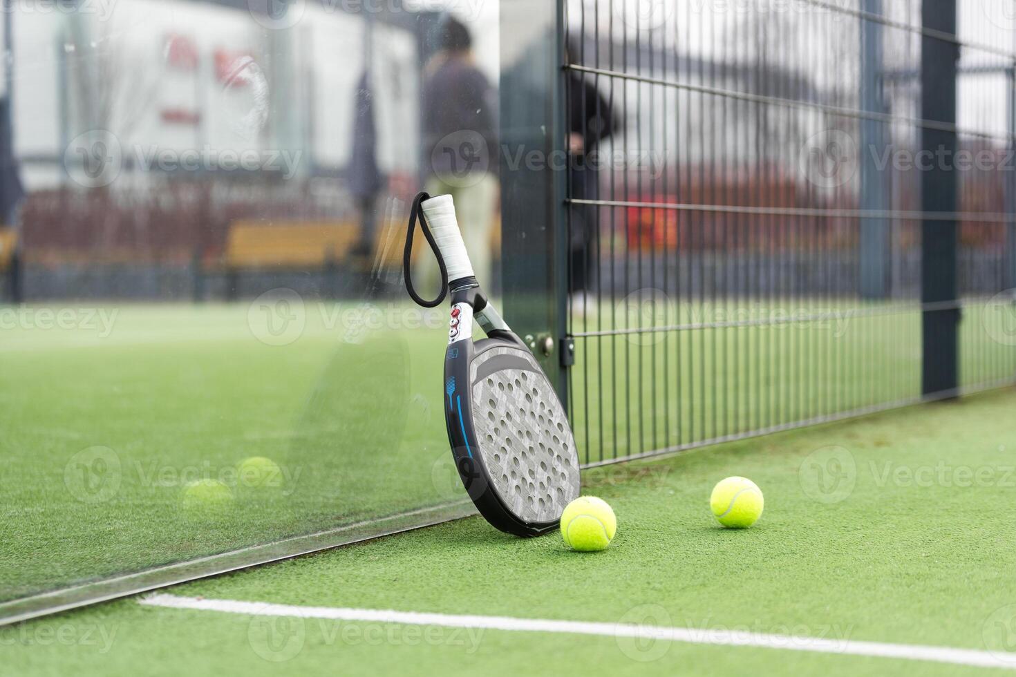 paddle tennis racket and balls on court photo