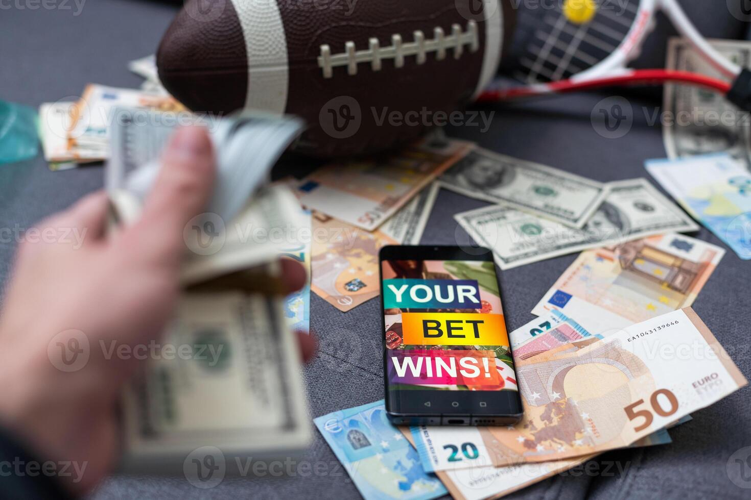 Smartphone with gambling mobile application, ball and money banknotes. Sport and betting concept photo