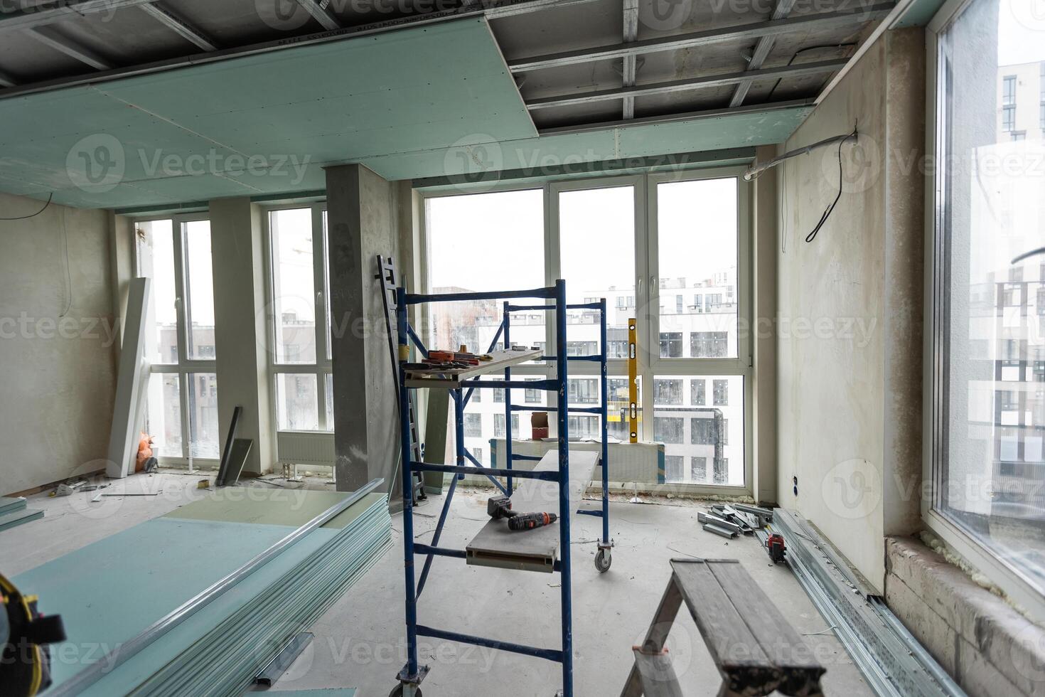 Ceiling installation with expert technicians In the room that is in the construction process. photo