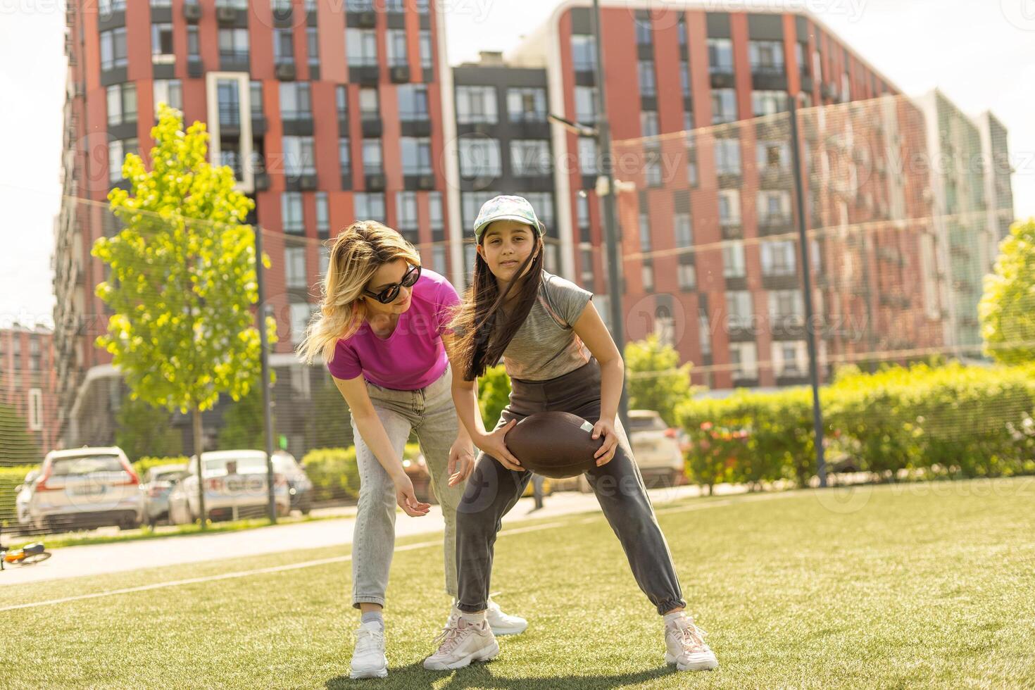 mother and daughter playing american football photo