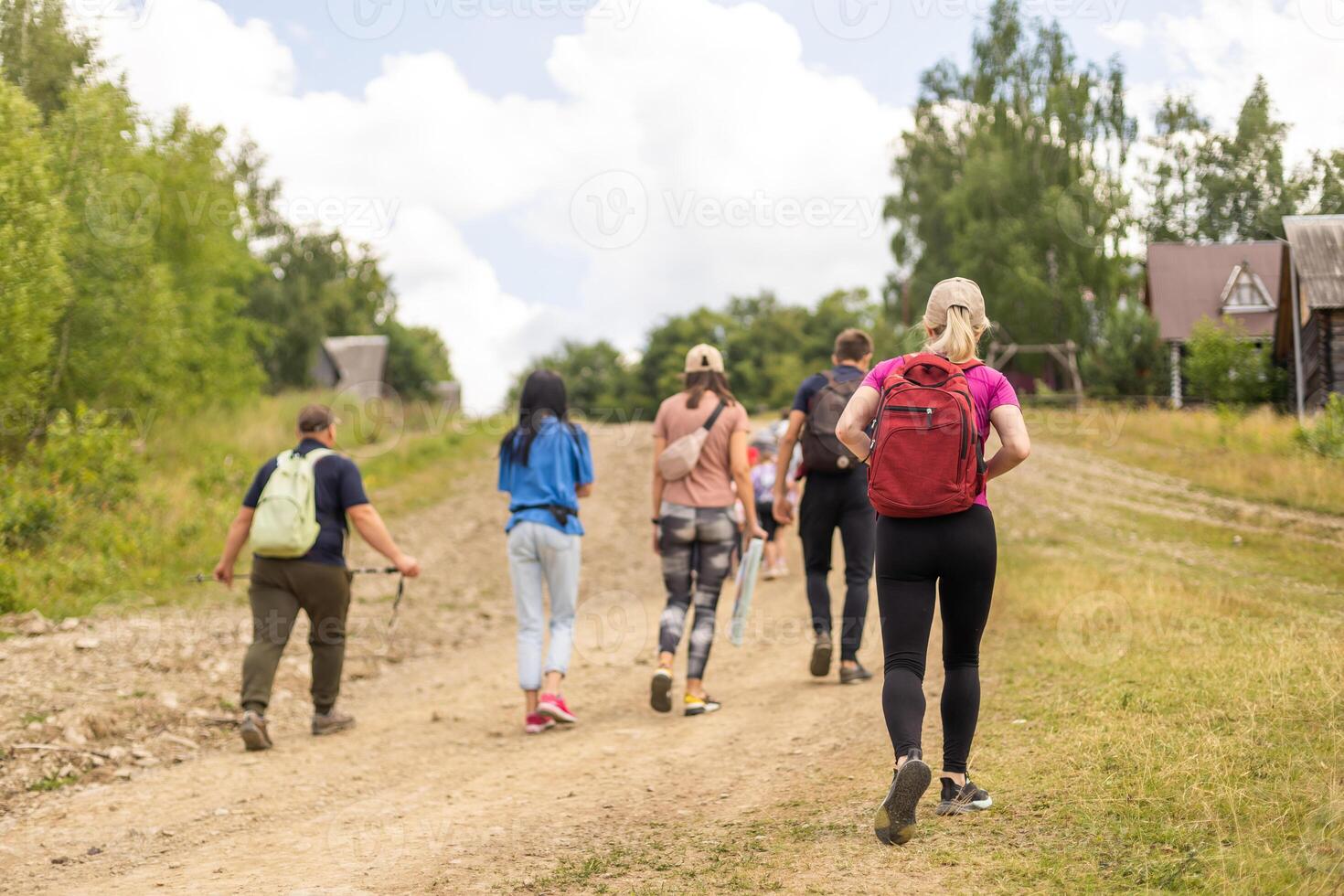 Group of friends hiking in nature in the mountains photo