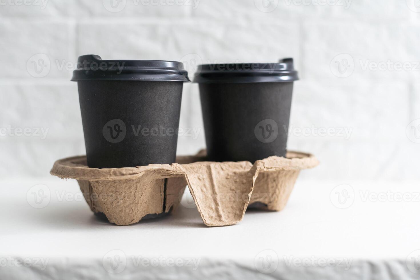 Two take-out coffee in holder. Isolated on a white. photo