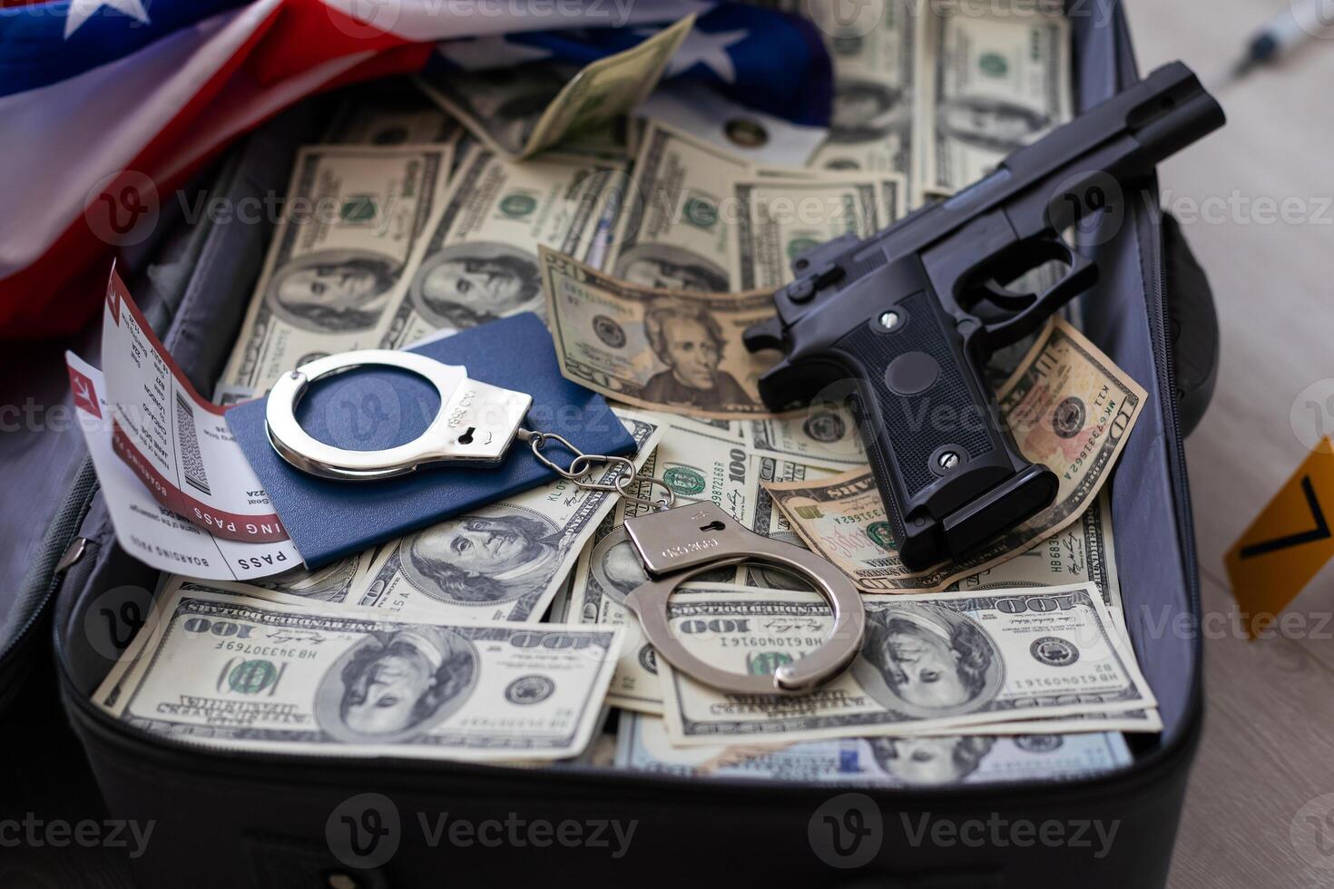 Suitcase with 100 dollar bills on grey background photo