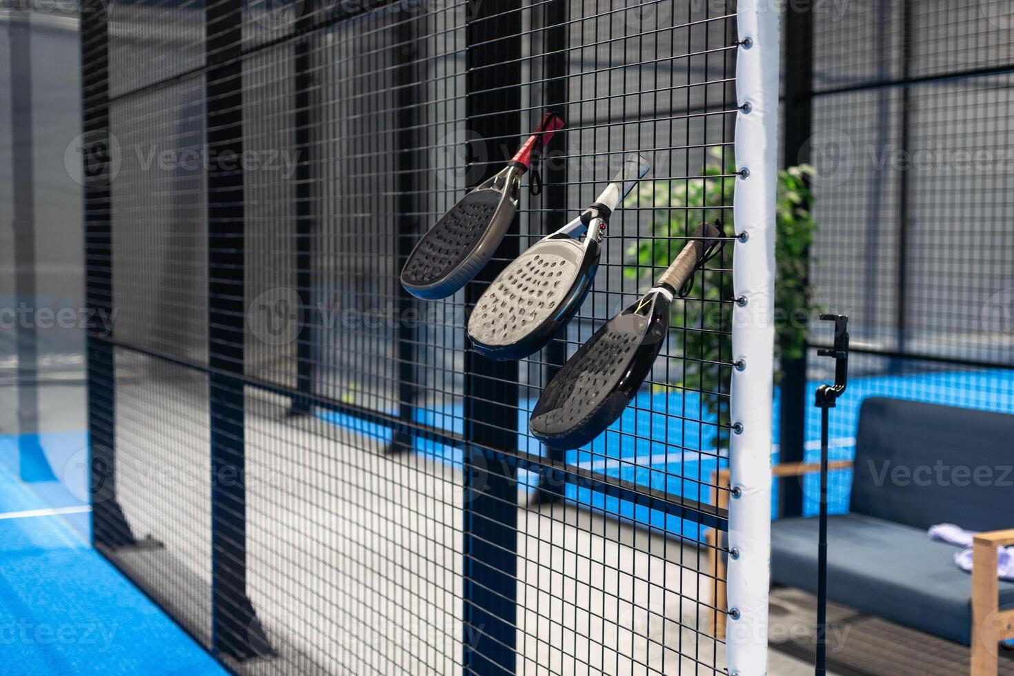 rackets and paddle balls on a court ready to play photo