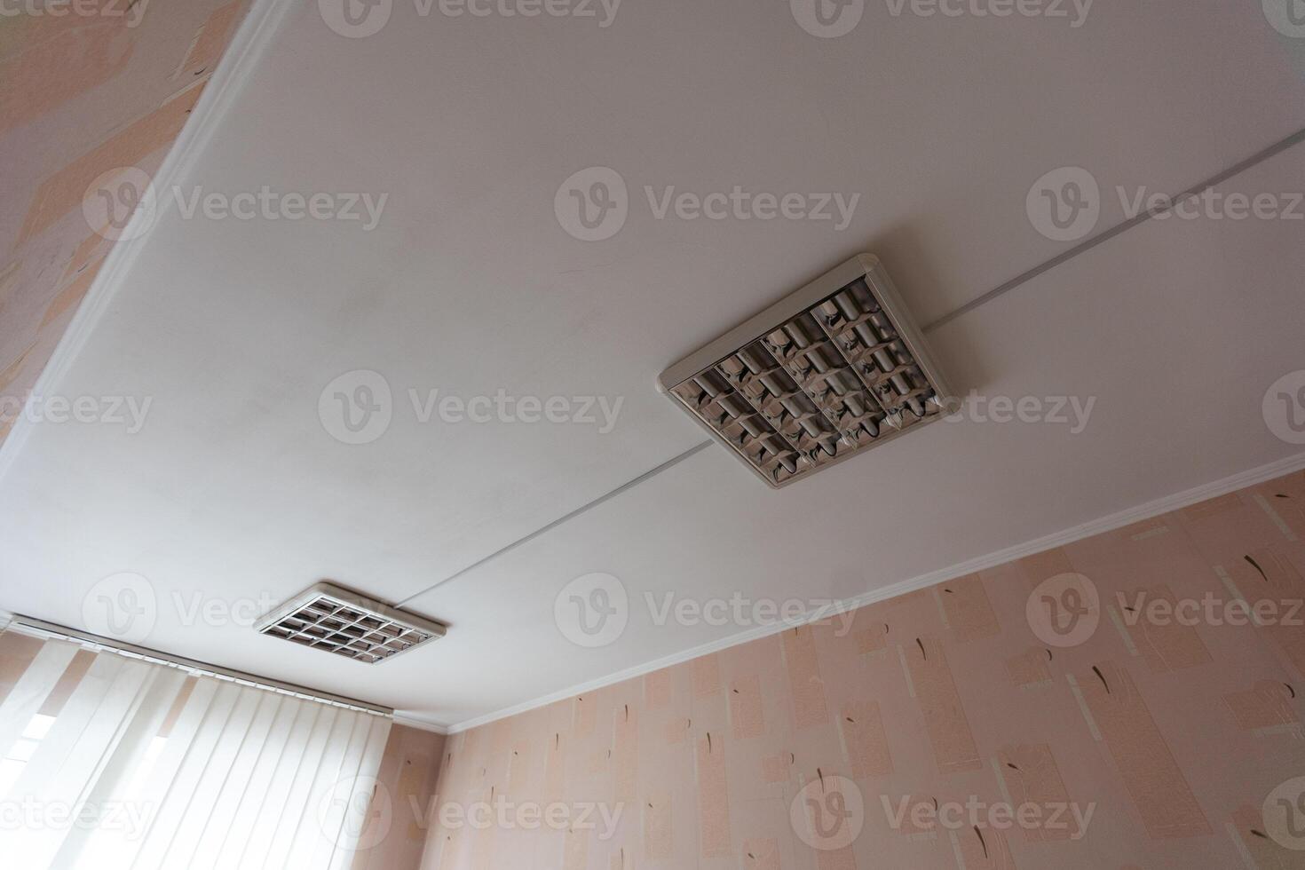 Texture or background, wallpaper of a white celing with daylight lamps in a public institution during the day. photo