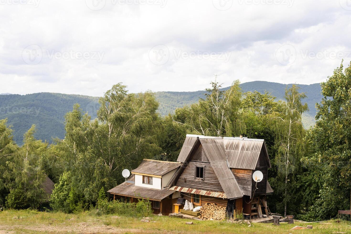 old wooden house in spring Carpathian mountains in Ukraine photo