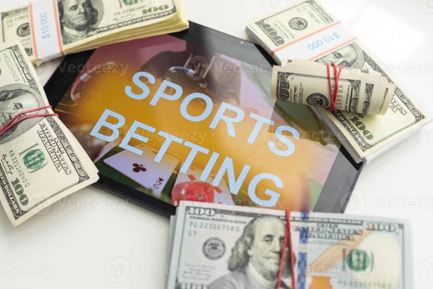 tablet pc with app for sport bets, on top of stacks of banknotes, white background, concept of online bets 3d render photo