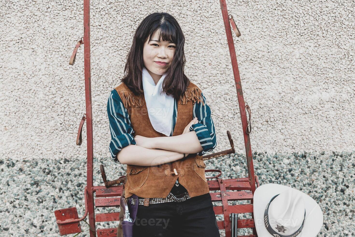 Portrait of a beautiful armed Chinese female cowgirl photo