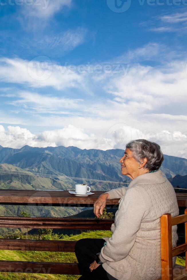 Senior woman tourist looking at the amazing landscapes of the Central Ranges on the ascent to the High of Letters between the cities of Fresno and Manizales in Colombia photo