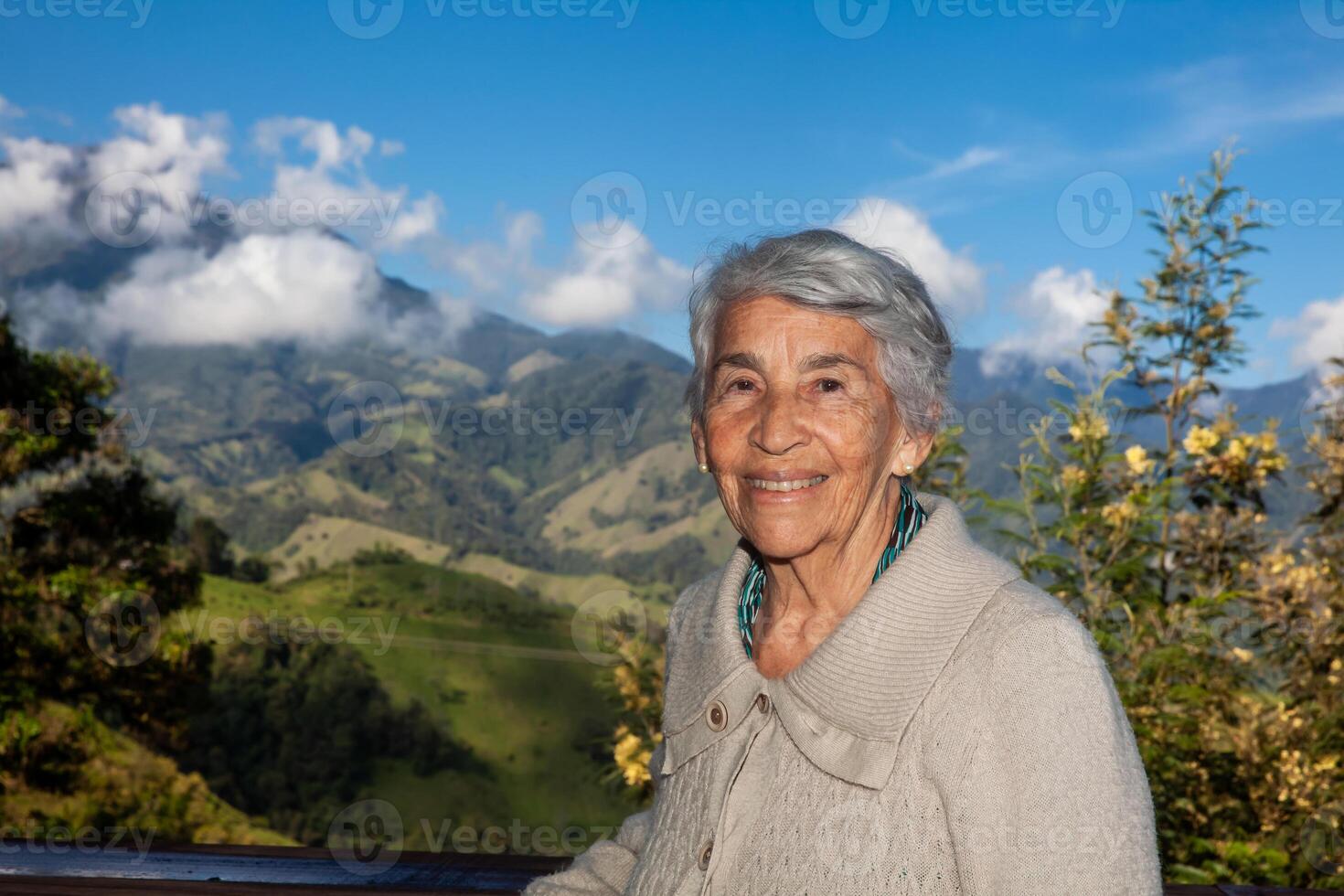 Senior woman tourist looking at the amazing landscapes of the Central Ranges on the ascent to the High of Letters between the cities of Fresno and Manizales in Colombia photo