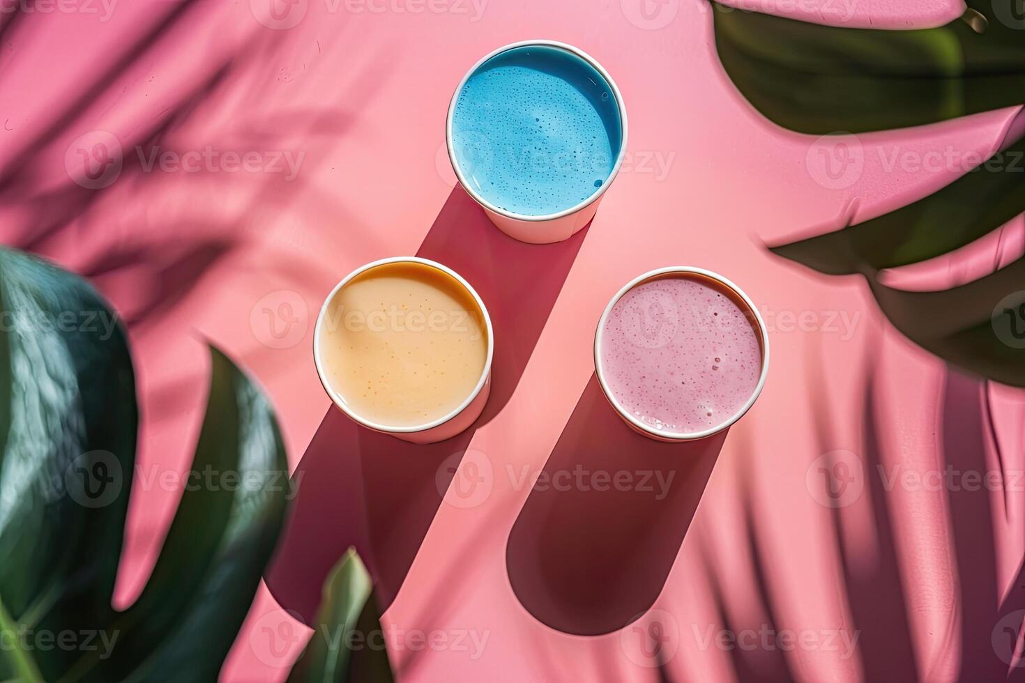 Some cups of smoothies, minimalist background, shadow leafs photo