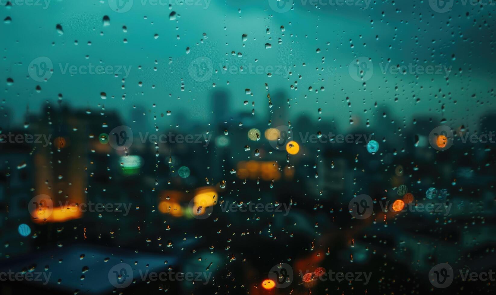 Raindrops streaking down a windowpane with a blurred cityscape in the background photo