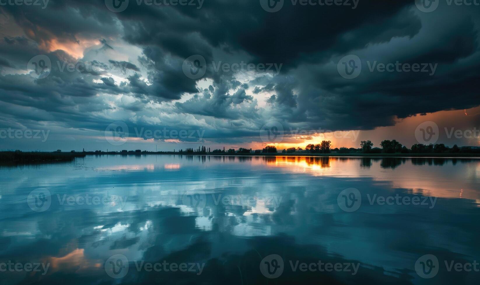 A dramatic stormy sky looming over the horizon, with dark clouds and flashes of lightning reflected in the waters of a lake photo
