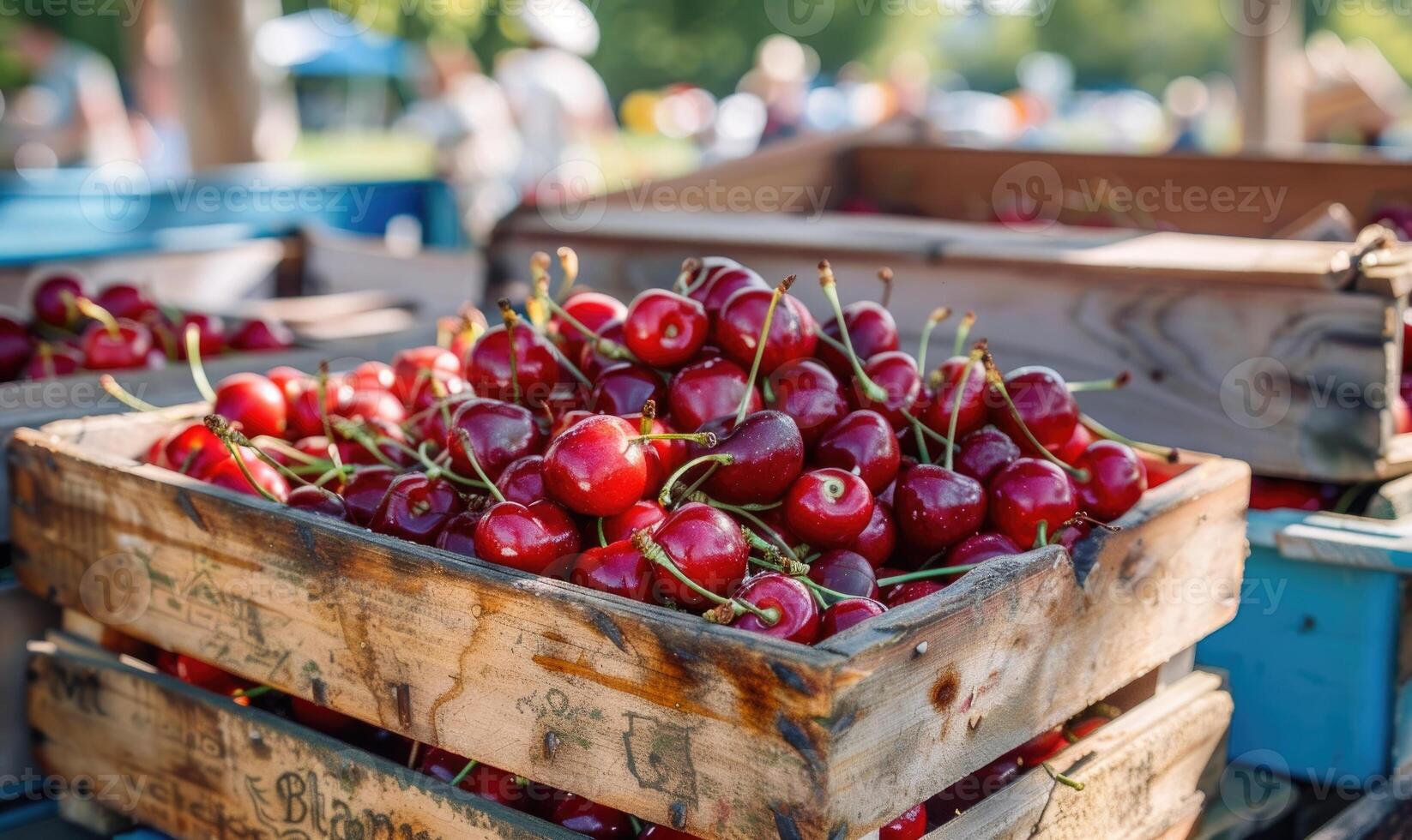 Ripe cherries displayed in a vintage fruit crate at a country fair photo