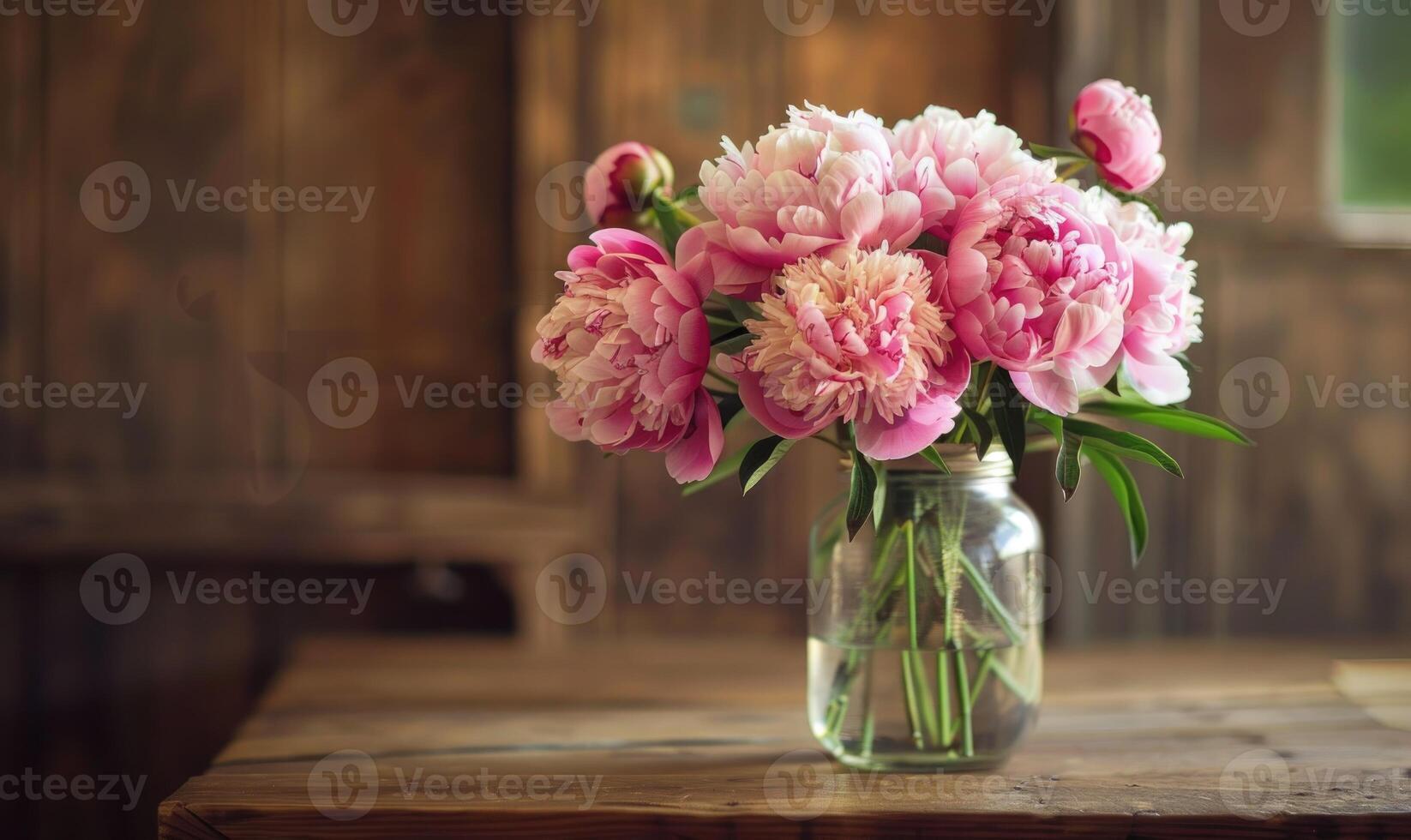 Peonies arranged in a mason jar vase for a rustic chic centerpiece photo