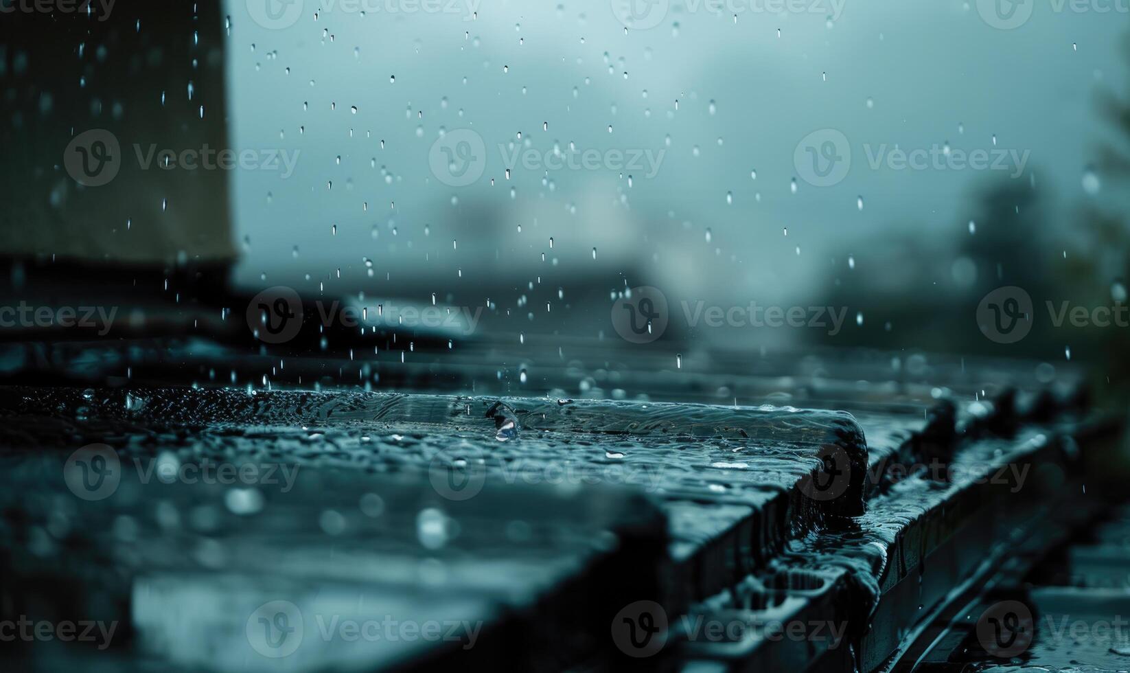 Raindrops cascading off the edge of a rooftop during a heavy downpour photo