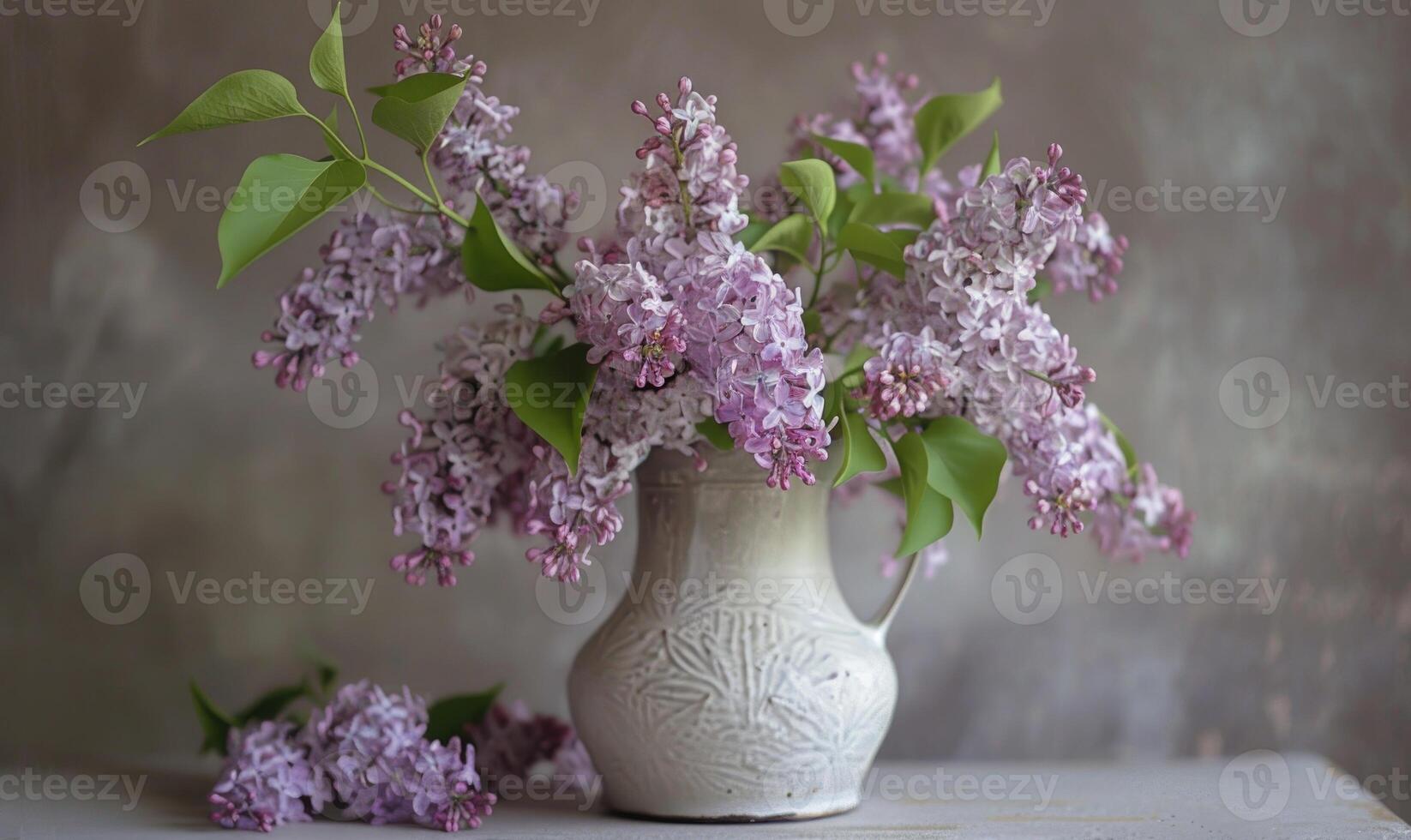 A lilac bouquet arranged in a vintage pitcher photo