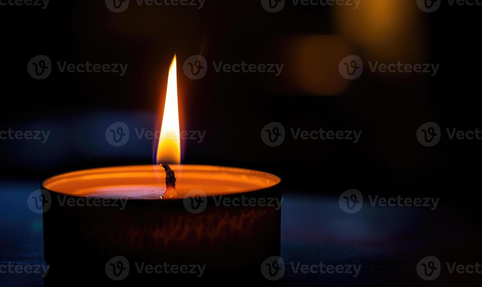 Close-up of a candle's gentle flicker illuminating a serene setting photo