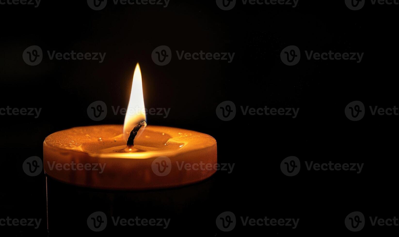 Close-up of a candle's gentle flicker illuminating a serene setting photo