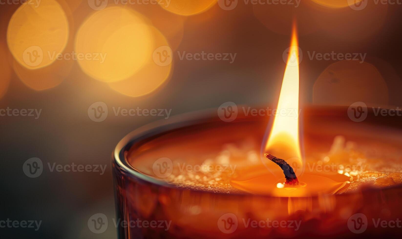 Close-up of a flickering candle flame casting a warm glow photo