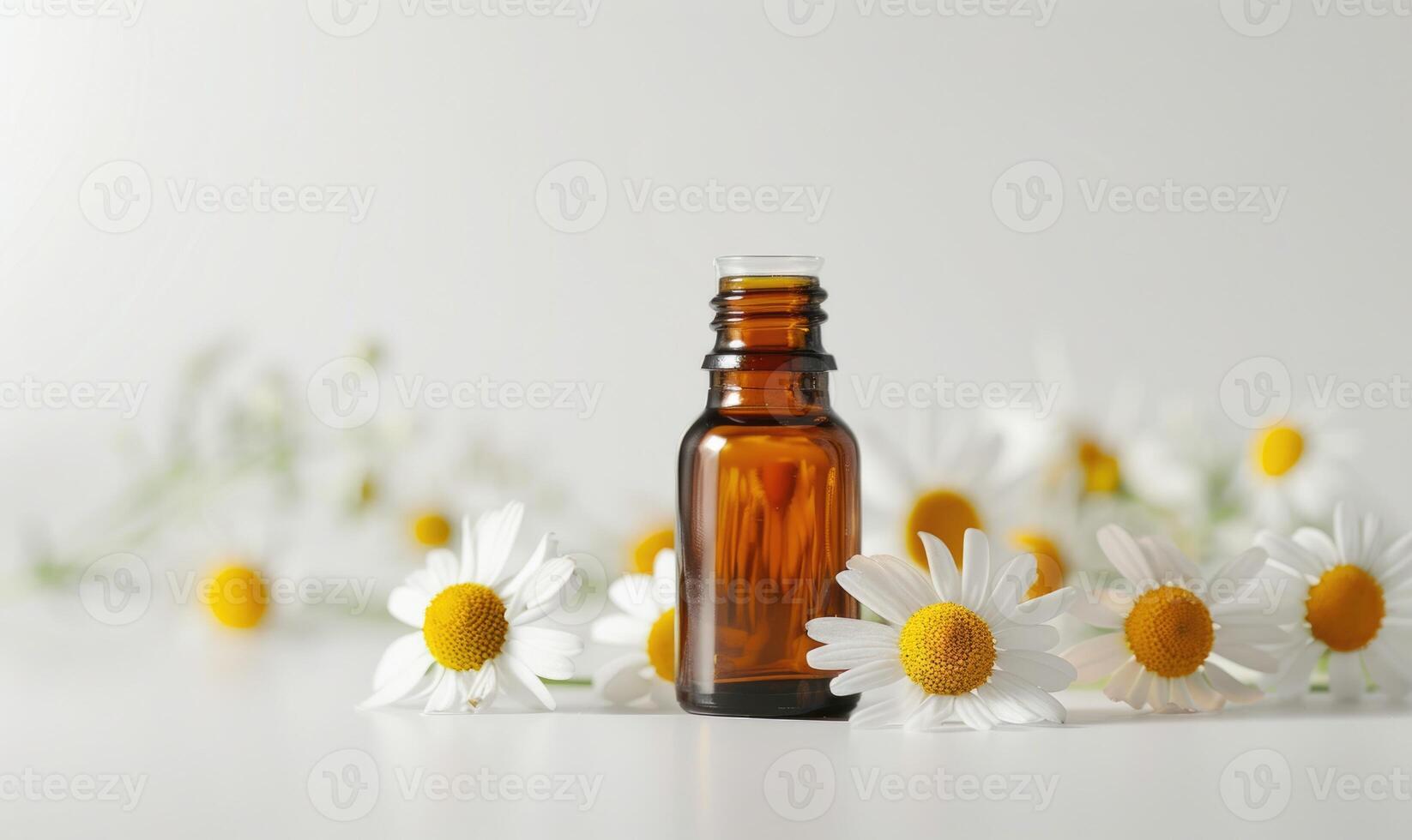 Chamomile essential oil bottle and chamomile flowers closeup, skin care cosmetic concept photo