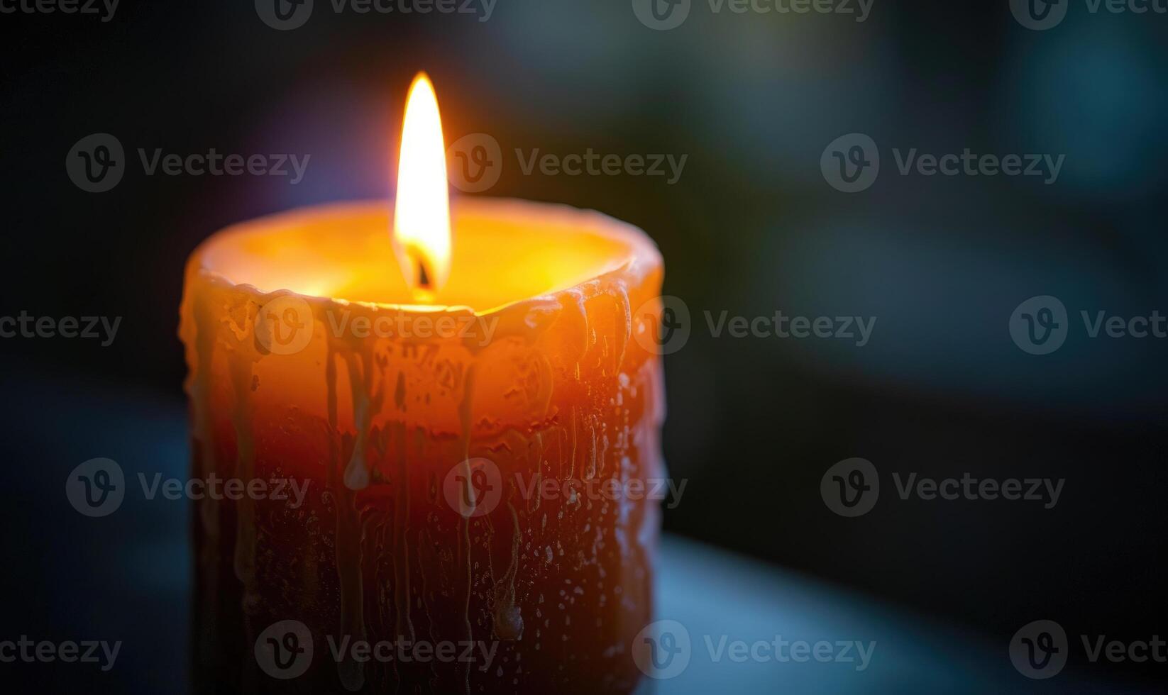 Close-up of a candle's gentle flicker illuminating a serene setting photo