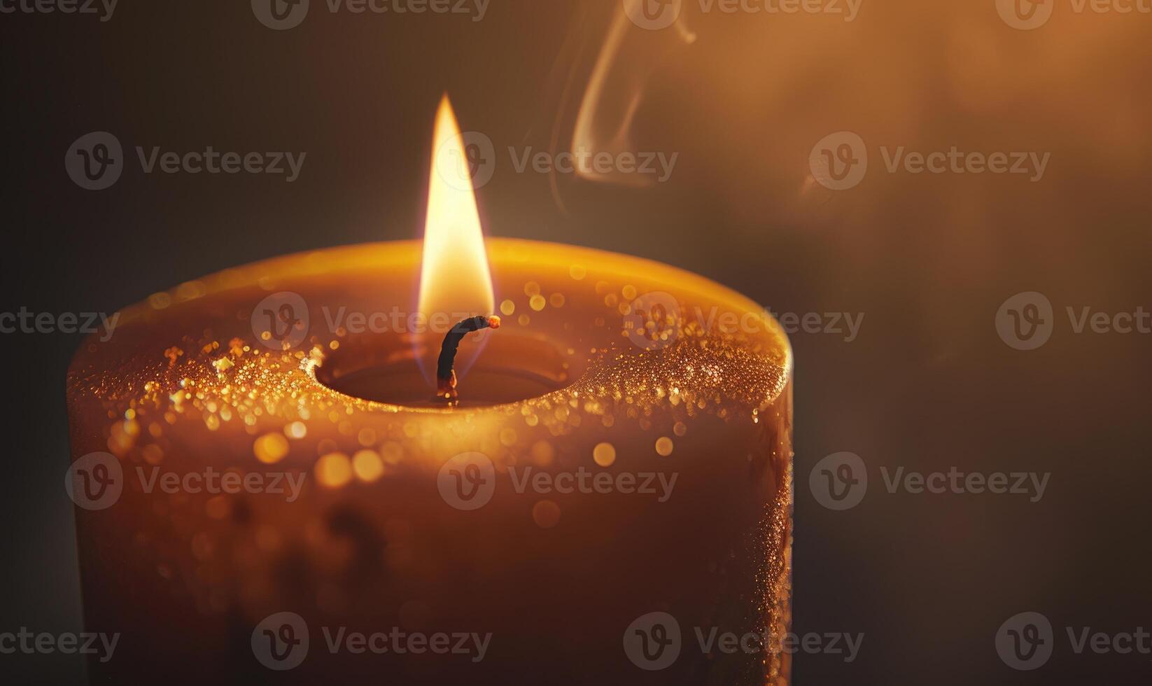 Close-up of a candle's gentle flicker illuminating a serene setting photo