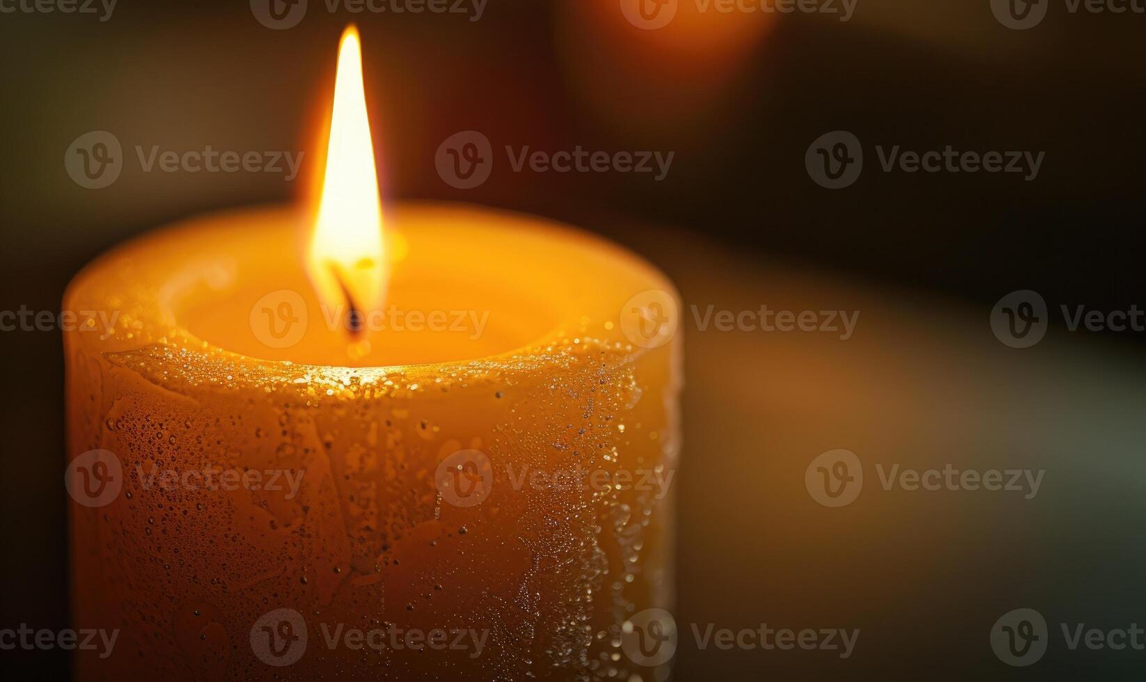 Close-up of a candle's gentle flicker illuminating a serene setting photo